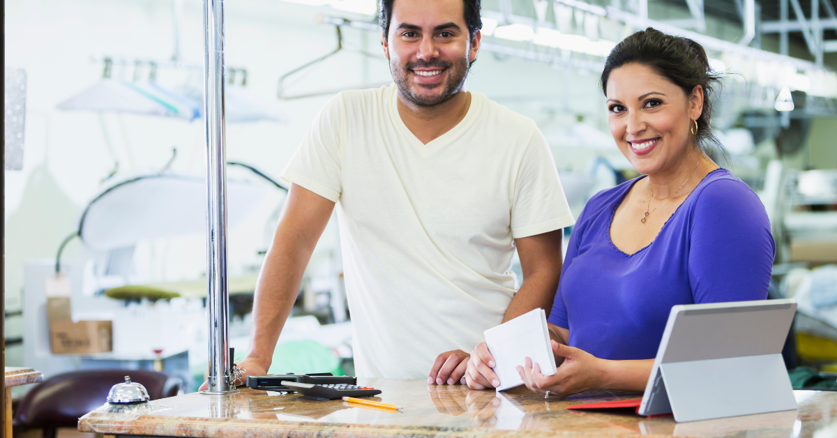 Two managers of a dry cleaning shop discuss their next promotional coupon