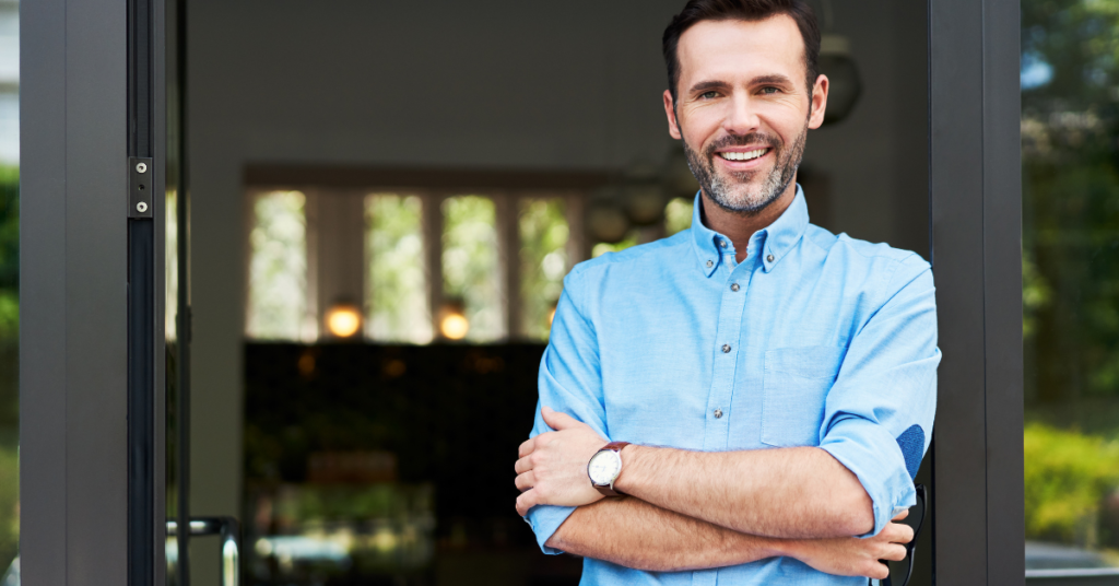 a business owner stands outside the office